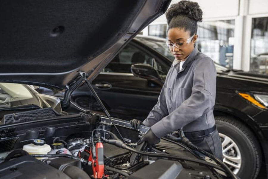 Woman Fixing Car Battery