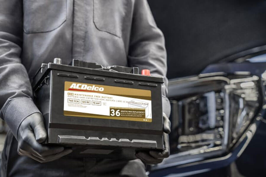 Man Carrying Car Battery