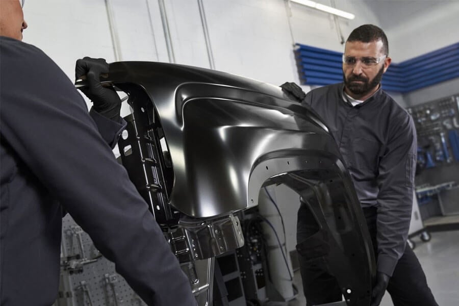 Men Holding Car Frame