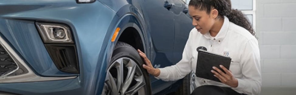 Woman Inspecting Tire