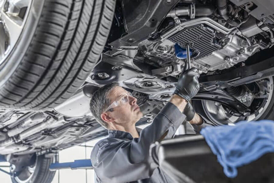 Man Under Car Frame Changing Out Oil