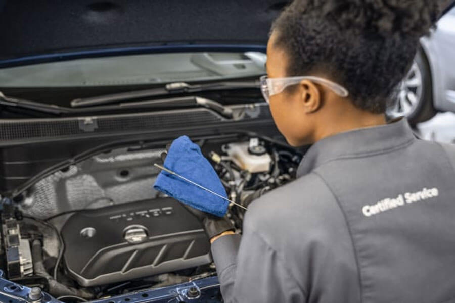 Woman Checking Oil Level