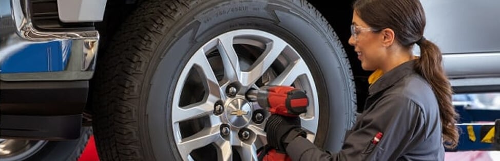Woman Bolting Car Tire