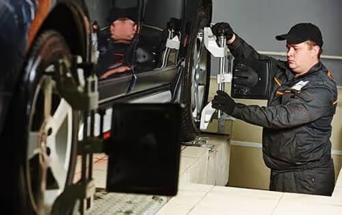 Man Adjusting Car Tire