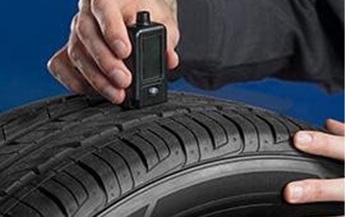 Man Checking Tire Wear