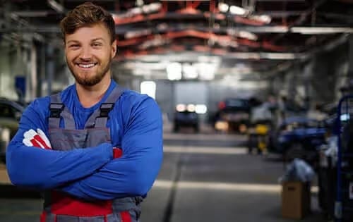 Man Posing for Photo in Car Hanger