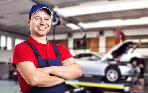 Man Posing for Photo in Car Shop