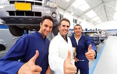 Men Giving Thumbs Up To Camera