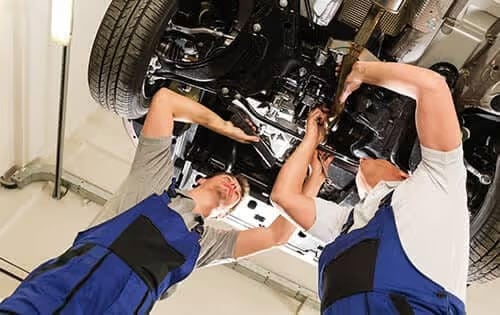 Men Working Under Car Frame