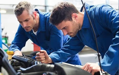 Men Working Under Car Hood